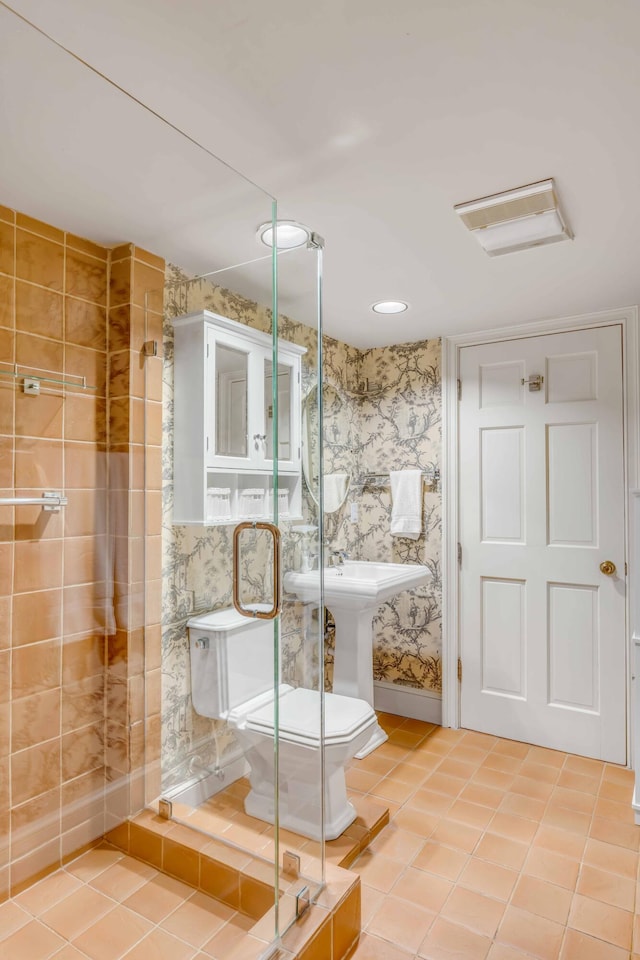 bathroom with tile patterned floors, a shower with shower door, and toilet