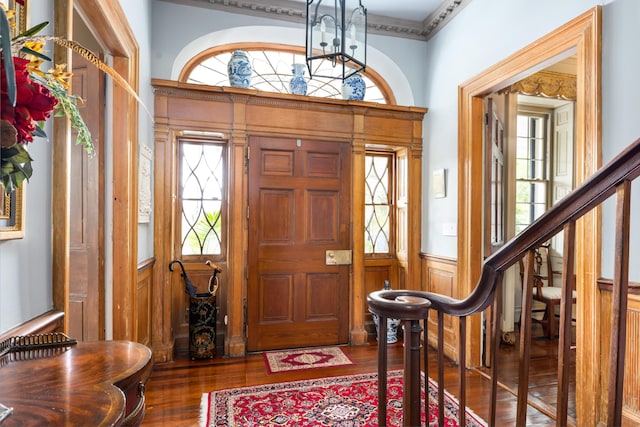 foyer featuring dark hardwood / wood-style floors and wooden walls