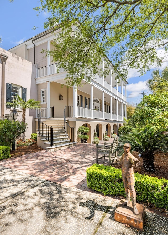 view of front of home with covered porch and a balcony