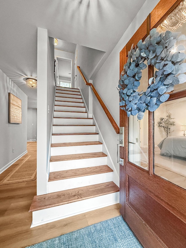 stairs with baseboards and wood finished floors