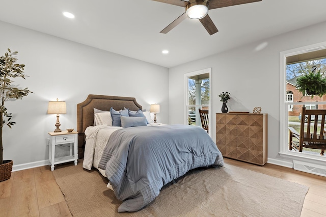 bedroom with baseboards, recessed lighting, wood finished floors, a ceiling fan, and access to outside