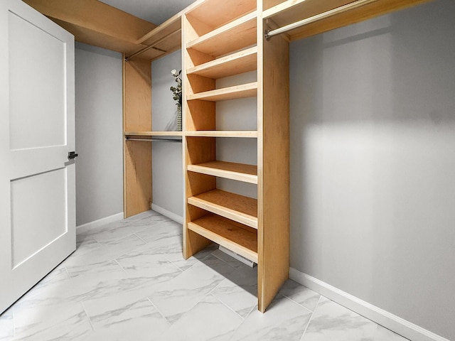 spacious closet with marble finish floor