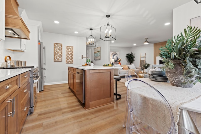 kitchen featuring brown cabinets, appliances with stainless steel finishes, light wood-type flooring, and custom range hood