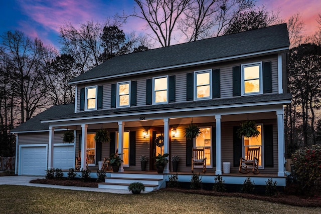 view of front facade featuring concrete driveway, an attached garage, covered porch, and a front lawn