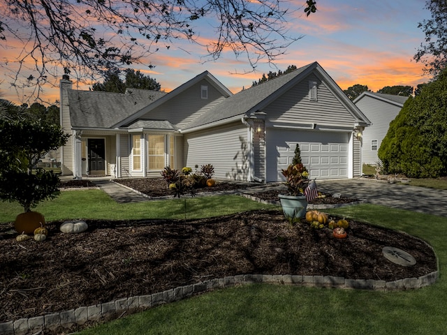 ranch-style home with a garage and a lawn