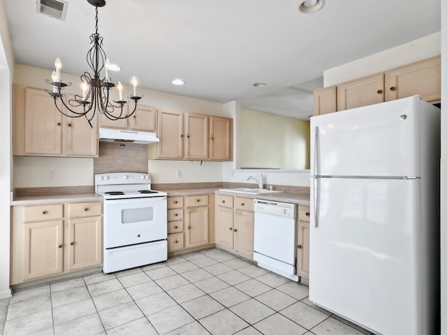 kitchen featuring light brown cabinets and white appliances