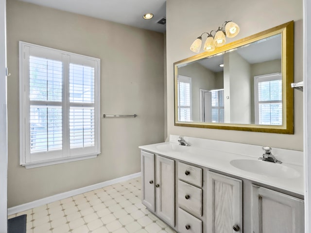 bathroom with vanity and a shower with door