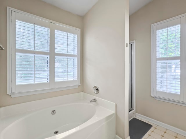 bathroom featuring independent shower and bath