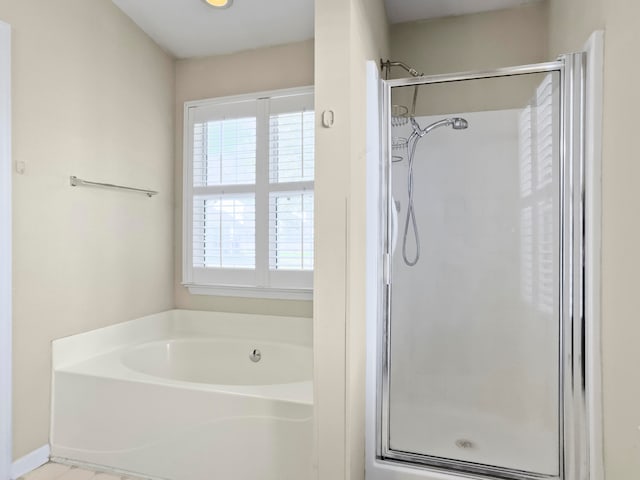 bathroom with shower with separate bathtub