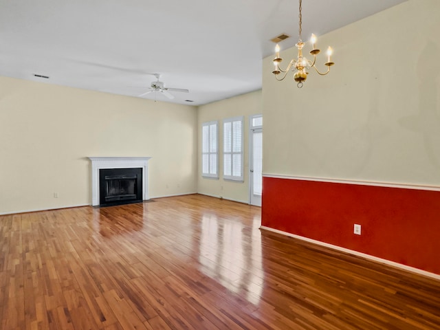 unfurnished living room with light hardwood / wood-style floors and ceiling fan with notable chandelier