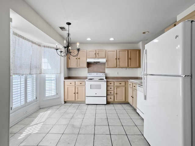 kitchen featuring light brown cabinetry, white appliances, light tile patterned floors, decorative light fixtures, and a notable chandelier