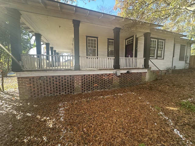 view of side of home with covered porch