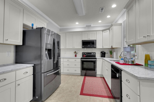 kitchen featuring white cabinets, crown molding, sink, light tile patterned floors, and appliances with stainless steel finishes