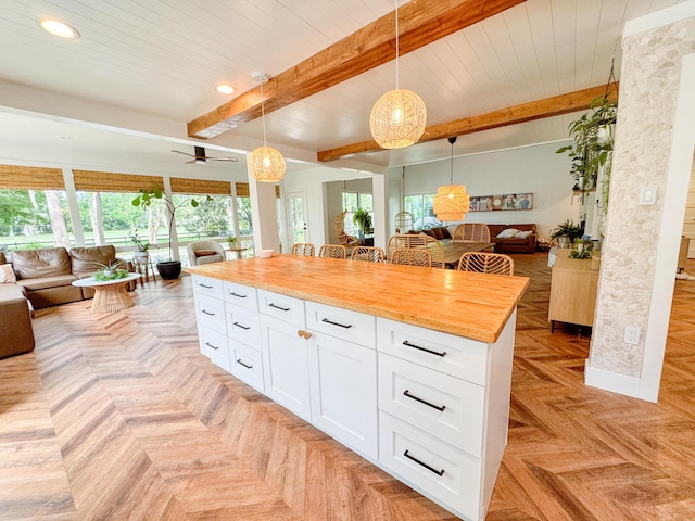 27 Fitzroy Dr, Charleston, SC 29414 - kitchen with open floor plan, wood counters, plenty of natural light, beamed ceiling, and white cabinets