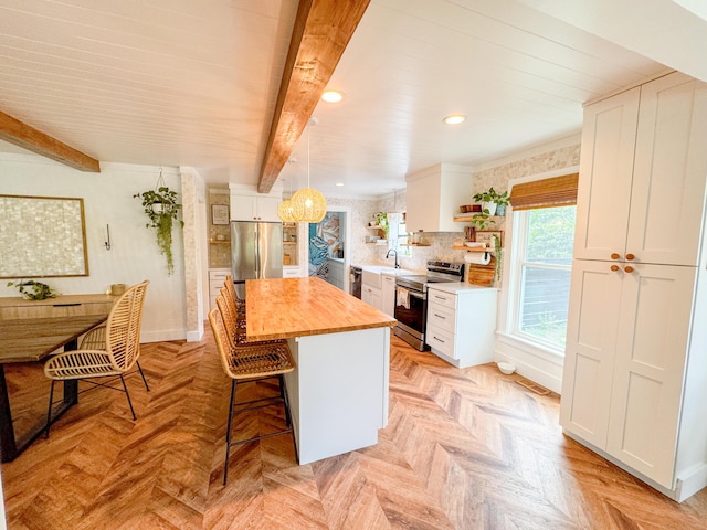 27 Fitzroy Dr, Charleston, SC 29414 - kitchen featuring stainless steel appliances, butcher block counters, a center island, white cabinets, and a breakfast bar area