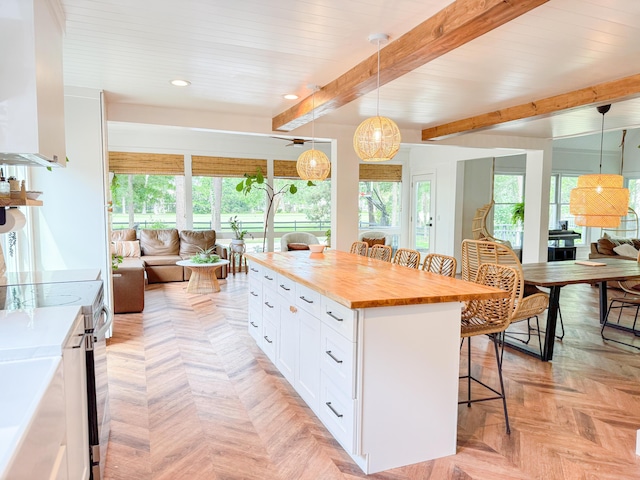 27 Fitzroy Dr, Charleston, SC 29414 - kitchen with wood counters, a breakfast bar area, open floor plan, white cabinetry, and recessed lighting