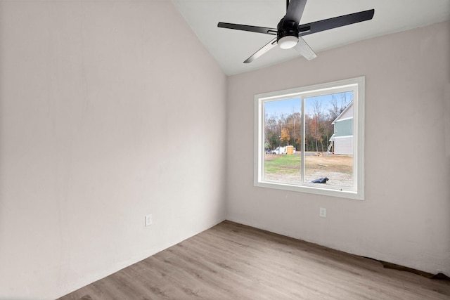 empty room featuring ceiling fan, plenty of natural light, and light hardwood / wood-style flooring