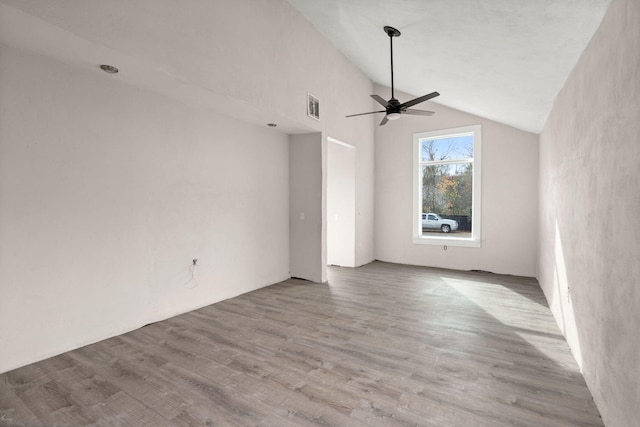 unfurnished living room featuring ceiling fan, light hardwood / wood-style floors, and vaulted ceiling