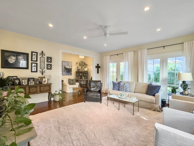 living room featuring ceiling fan, french doors, and dark wood-type flooring