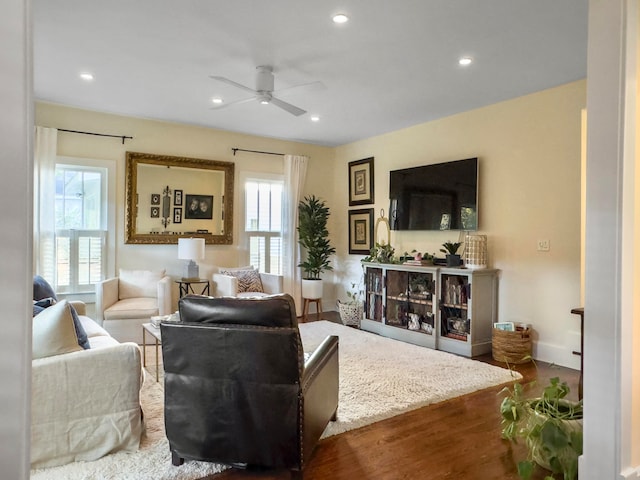 living room featuring ceiling fan, hardwood / wood-style flooring, and a healthy amount of sunlight