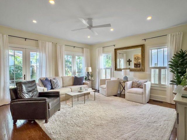 living room featuring wood-type flooring and ceiling fan