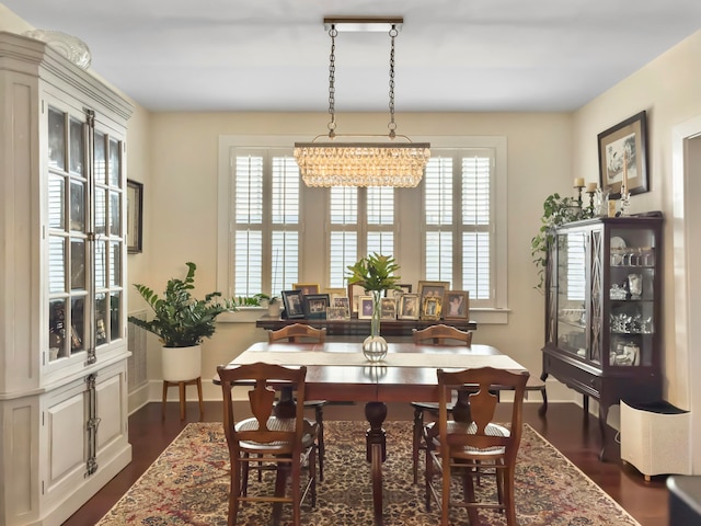 dining space with plenty of natural light and dark hardwood / wood-style floors