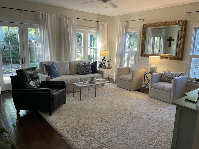 living room with french doors, a wealth of natural light, wood-type flooring, and ceiling fan