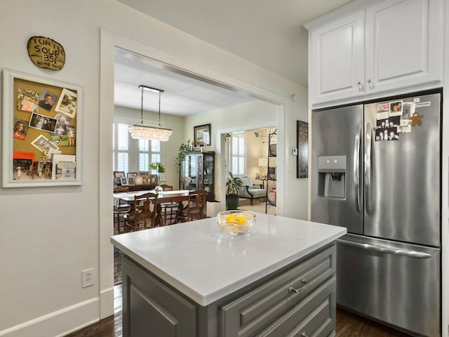 kitchen with gray cabinets, a center island, dark hardwood / wood-style floors, stainless steel refrigerator with ice dispenser, and white cabinetry