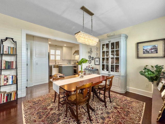 dining space with an inviting chandelier and dark wood-type flooring