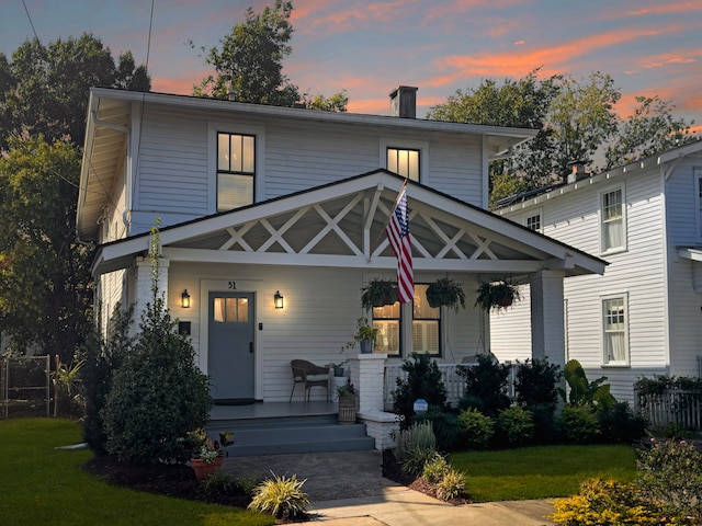 view of front facade featuring a yard and a porch