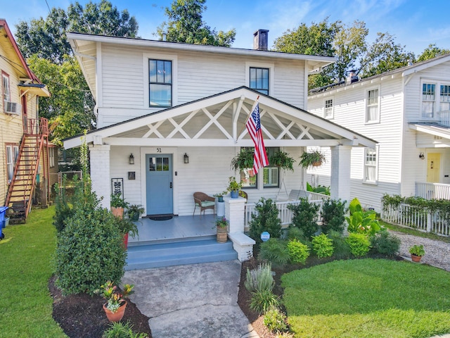 view of front of property featuring a front lawn and a porch