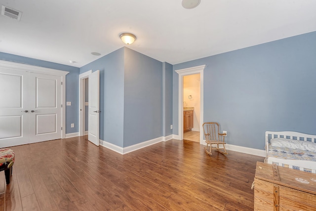unfurnished bedroom featuring baseboards and wood finished floors