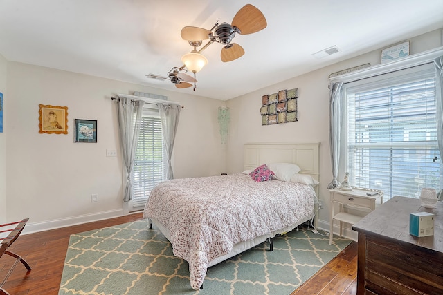 bedroom with dark wood-style flooring, baseboards, a ceiling fan, and access to exterior