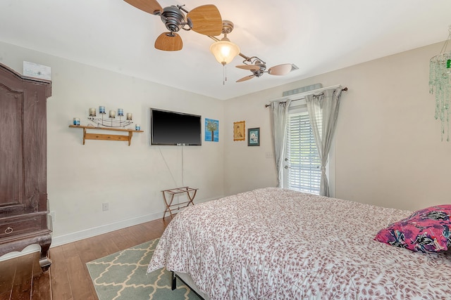 bedroom featuring hardwood / wood-style flooring, ceiling fan, baseboards, and access to outside