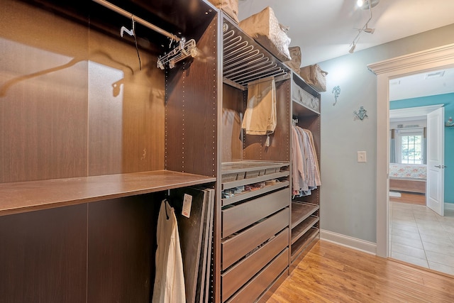 walk in closet featuring wood finished floors