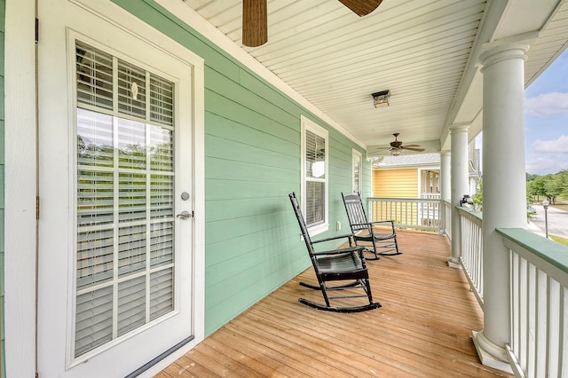 wooden terrace with ceiling fan and covered porch