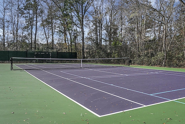 view of tennis court with fence and community basketball court