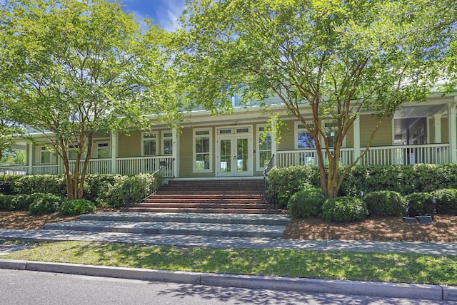 property entrance featuring french doors and a porch