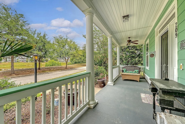 balcony with a porch and a ceiling fan