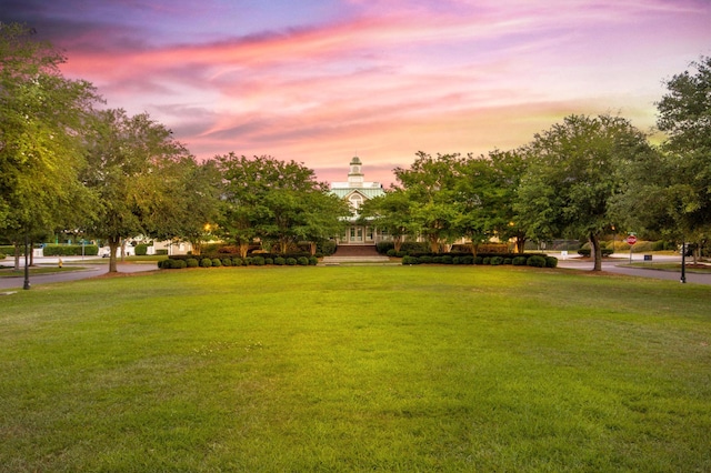 view of property's community with a lawn