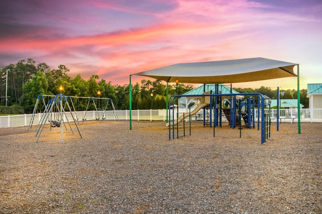 playground at dusk featuring fence