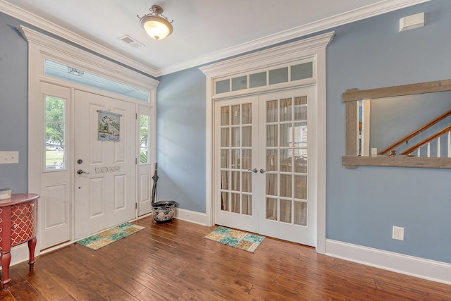 foyer entrance featuring french doors, wood finished floors, crown molding, and baseboards