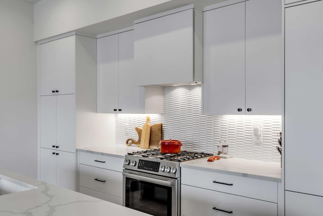 405 Spartina Ln Unit 405, Charleston, SC 29492 - kitchen with stainless steel gas stove, white cabinets, modern cabinets, backsplash, and light stone countertops