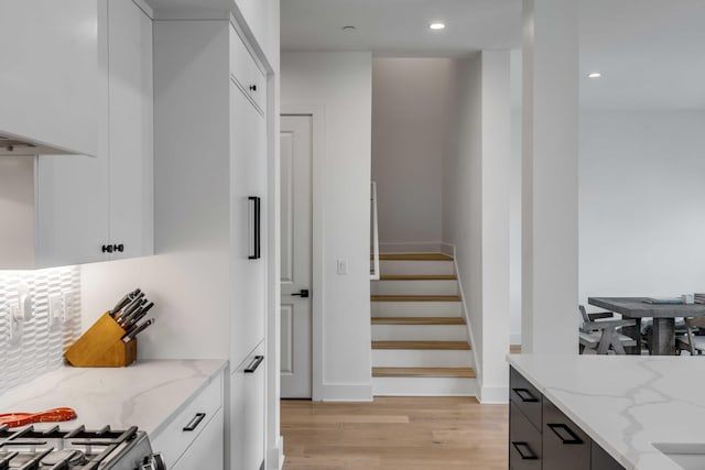 405 Spartina Ln Unit 405, Charleston, SC 29492 - kitchen with light wood finished floors, white cabinetry, light stone counters, recessed lighting, and modern cabinets