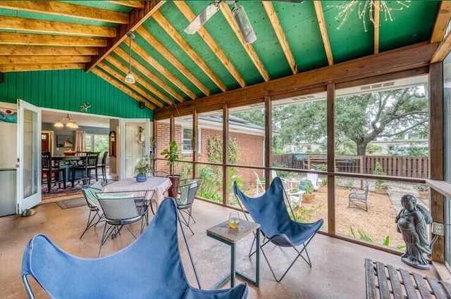 sunroom / solarium featuring lofted ceiling