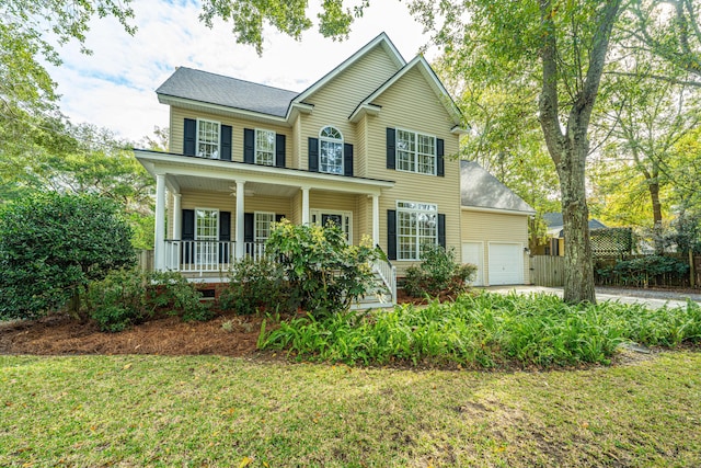 colonial home with a porch and a front lawn