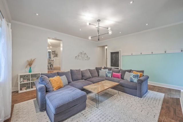 living room with wood-type flooring, crown molding, and a chandelier