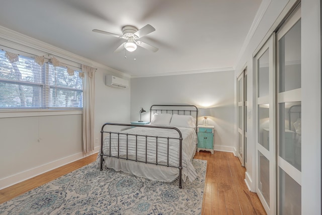 bedroom with a wall mounted AC, ceiling fan, hardwood / wood-style flooring, and ornamental molding