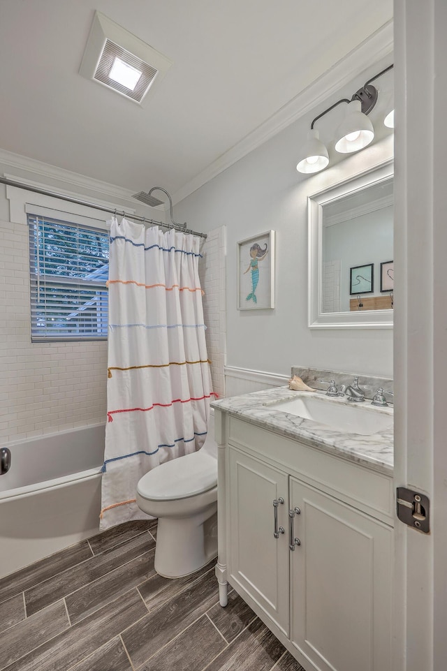 full bathroom featuring vanity, crown molding, shower / bathtub combination with curtain, and toilet