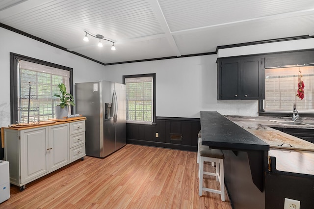 kitchen with sink, crown molding, white cabinetry, stainless steel refrigerator with ice dispenser, and light hardwood / wood-style floors